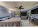 Bright bedroom featuring a ceiling fan, vinyl flooring, and a well-lit office desk at 39650 Us Highway 19 N # 743, Tarpon Springs, FL 34689