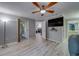 Bedroom featuring wood-look floors, a ceiling fan, and grey walls, including access to a balcony at 39650 Us Highway 19 N # 743, Tarpon Springs, FL 34689