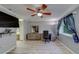Bedroom featuring wood-look floors, a ceiling fan, and a closet; with an office setup and grey walls at 39650 Us Highway 19 N # 743, Tarpon Springs, FL 34689
