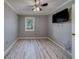 Bright bedroom with wood-look floors, a ceiling fan, freshly painted walls, and natural light at 39650 Us Highway 19 N # 743, Tarpon Springs, FL 34689