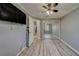 Bedroom with wood-look flooring, mirrored closet doors, ceiling fan, and freshly painted walls at 39650 Us Highway 19 N # 743, Tarpon Springs, FL 34689