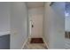 Inviting entryway featuring light gray walls, white trim, and a modern light-colored wood floor at 39650 Us Highway 19 N # 743, Tarpon Springs, FL 34689