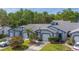 Inviting townhome with a well-manicured lawn, lush greenery, and a private two-car garage at 39650 Us Highway 19 N # 743, Tarpon Springs, FL 34689