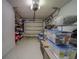 Well-organized garage space with storage shelves, bins, and overhead lighting for easy access at 39650 Us Highway 19 N # 743, Tarpon Springs, FL 34689