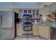Well-equipped kitchen with stainless steel appliances and granite countertops and storage at 39650 Us Highway 19 N # 743, Tarpon Springs, FL 34689