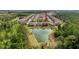 Aerial view of home's backyard with pond bordered by trees in community at 4024 Woods Rider Loop, Odessa, FL 33556