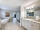 Bright bathroom with freestanding tub, frameless glass shower, and double sink vanity at 4024 Woods Rider Loop, Odessa, FL 33556