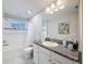 Updated bathroom with granite vanity, bath-shower, and tiled floor at 4024 Woods Rider Loop, Odessa, FL 33556