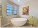 Bright bathroom featuring free-standing tub and natural light at 4024 Woods Rider Loop, Odessa, FL 33556