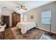Relaxing bedroom with a ceiling fan, natural light, and wood-look tile flooring at 4024 Woods Rider Loop, Odessa, FL 33556