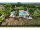 Inviting community pool area with comfortable lounge chairs, lush landscaping, and a wooden deck for relaxation at 4024 Woods Rider Loop, Odessa, FL 33556