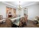 Formal dining room with a glass-top table, chandelier, and hardwood floors at 4024 Woods Rider Loop, Odessa, FL 33556