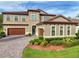 Beautiful two-story home with a well-manicured lawn and a three-car garage with paver driveway at 4024 Woods Rider Loop, Odessa, FL 33556