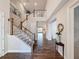Grand two-story foyer with hardwood floors, staircase, and elegant decor at 4024 Woods Rider Loop, Odessa, FL 33556