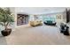 Large living room with carpet, large bookcase and comfortable seating area at 4024 Woods Rider Loop, Odessa, FL 33556