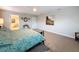 Spacious main bedroom with carpeted floor, ceiling fan, and ensuite bathroom at 4024 Woods Rider Loop, Odessa, FL 33556