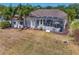Aerial view featuring the home's outdoor space with a screened-in lanai and lush surroundings at 5113 Epping Ln, Zephyrhills, FL 33541