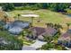 Beautiful aerial shot of a home on a golf course with mature trees and landscaping at 5113 Epping Ln, Zephyrhills, FL 33541