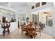 Open-concept dining room with modern chandelier and view of outdoor living at 5113 Epping Ln, Zephyrhills, FL 33541