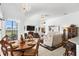 Inviting dining area adjacent to living space with seamless flow and backyard view at 5113 Epping Ln, Zephyrhills, FL 33541