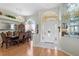 Elegant foyer with chandelier, hardwood floors, and a dining area with a large table at 5113 Epping Ln, Zephyrhills, FL 33541