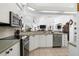 Contemporary kitchen with stainless steel appliances and view to the combined living space at 5113 Epping Ln, Zephyrhills, FL 33541