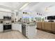 Open-concept kitchen with stainless appliances and views of the combined living space at 5113 Epping Ln, Zephyrhills, FL 33541