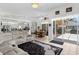 Open concept living room showcasing the modern finishes, dining area, and patio access at 5113 Epping Ln, Zephyrhills, FL 33541