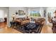 Cozy living room with hardwood floors, plush sofas, and views of the outdoor patio at 5113 Epping Ln, Zephyrhills, FL 33541