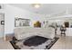 Cozy living room featuring neutral sectional sofa, decorative rug, and open kitchen at 5113 Epping Ln, Zephyrhills, FL 33541