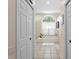The bathroom features a tiled tub, an arched window, and white cabinets at 5113 Epping Ln, Zephyrhills, FL 33541