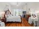 Bright bedroom with a decorative wood bed frame, chandelier, and views of the outdoors at 5113 Epping Ln, Zephyrhills, FL 33541
