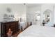 The bedroom features a lovely dresser and vanity with views of the ensuite bathroom at 5113 Epping Ln, Zephyrhills, FL 33541