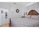 Bedroom with wood bed frame, laminate flooring, and ensuite bathroom entrance at 5113 Epping Ln, Zephyrhills, FL 33541
