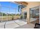 Enjoy serene golf course views from this screened patio that offers access to the house through multiple glass doors at 5113 Epping Ln, Zephyrhills, FL 33541
