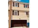 View of the exterior of the home featuring an attached garage and traditional shuttered windows at 5407 Sweetwater Terrace Cir # 5407, Tampa, FL 33634