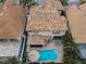 Aerial view of house with a private pool, tile roof, and lush greenery in a desirable neighborhood at 5807 Cay Cove Ct, Tampa, FL 33615