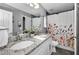 Bathroom with double sink, granite counters, and floral shower curtain at 5807 Cay Cove Ct, Tampa, FL 33615