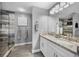 Bathroom featuring double sinks with granite countertops and a glass enclosed shower with decorative tile at 5807 Cay Cove Ct, Tampa, FL 33615