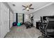 Bedroom with exercise equipment, including yoga balls, elliptical, and TV at 5807 Cay Cove Ct, Tampa, FL 33615