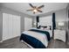 Bedroom with grey walls, wood-look flooring, ceiling fan, and modern decor at 5807 Cay Cove Ct, Tampa, FL 33615