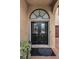 Inviting front entry with arched doorway and stylish double doors at 5807 Cay Cove Ct, Tampa, FL 33615