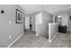 Upstairs hallway featuring wood-look tile floors, neutral paint, and access to several rooms at 5807 Cay Cove Ct, Tampa, FL 33615
