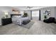 Spacious main bedroom with neutral decor, plush carpet, and a large window at 5807 Cay Cove Ct, Tampa, FL 33615