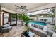 Covered patio with outdoor seating overlooking a sparkling pool and lush landscaping at 5807 Cay Cove Ct, Tampa, FL 33615
