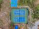 Overhead view of community tennis and basketball courts with well-maintained green and blue surfaces at 5807 Cay Cove Ct, Tampa, FL 33615