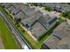 Aerial view of back yard showing patio, solar panels, and mature landscaping at 597 Ozona Village Dr, Palm Harbor, FL 34683