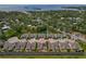 An aerial view showcasing the community layout and proximity to the water, and surrounding greenery at 597 Ozona Village Dr, Palm Harbor, FL 34683