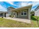 Backyard patio with brick pavers, fan, and a view of the house and yard at 597 Ozona Village Dr, Palm Harbor, FL 34683