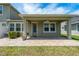 Backyard patio with brick pavers, fan, and a view of the house with green grass at 597 Ozona Village Dr, Palm Harbor, FL 34683